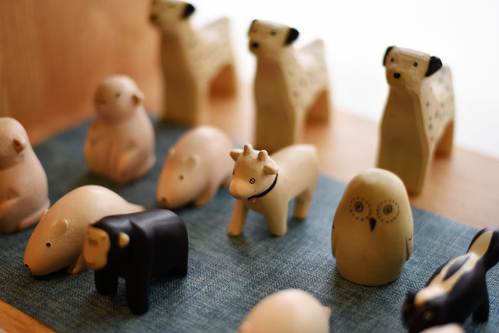 Wooden animal toys arranged on a surface, representing toys an aunt keeps until niece returns stolen trinkets. Wooden animal toys arranged on a surface, representing toys an aunt keeps until niece returns stolen trinkets.
