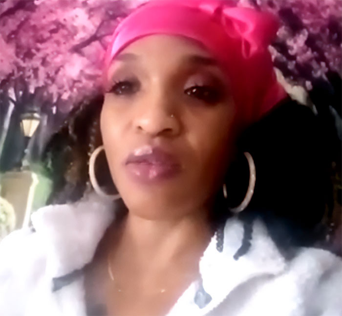 Woman with pink headscarf and hoop earrings in front of floral backdrop, linked to runaway girl found story. Woman with pink headscarf and hoop earrings in front of floral backdrop, linked to runaway girl found story.