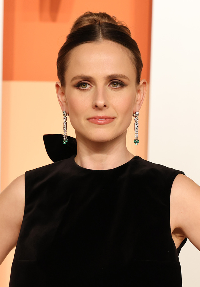 Woman in a black dress with elaborate earrings, related to Timothée Chalamet, appearing in a vibrant setting. Woman in a black dress with elaborate earrings, related to Timothée Chalamet, appearing in a vibrant setting.