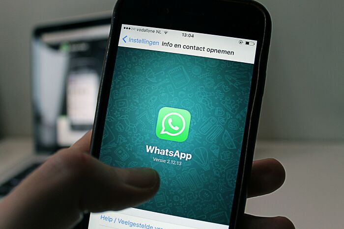 WhatsApp screen displayed on smartphone, illustrating adult experiences similar to being picked last in gym class.