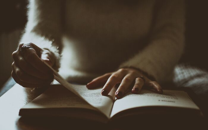 Hands turning pages of a book, searching for the perfect read. Hands turning pages of a book, searching for the perfect read.