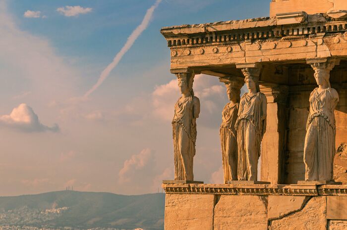 Ancient Greek architecture with caryatids under a vibrant sky capturing bizarre history. Ancient Greek architecture with caryatids under a vibrant sky capturing bizarre history.