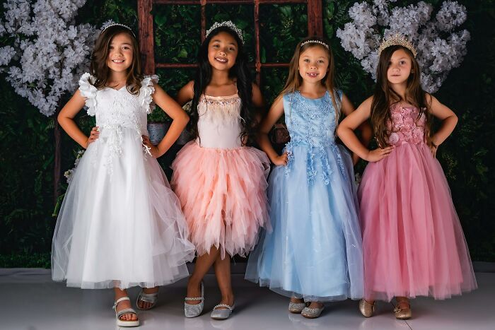 Young girls in princess dresses and tiaras, representing weirdest thing society accepts as normal.