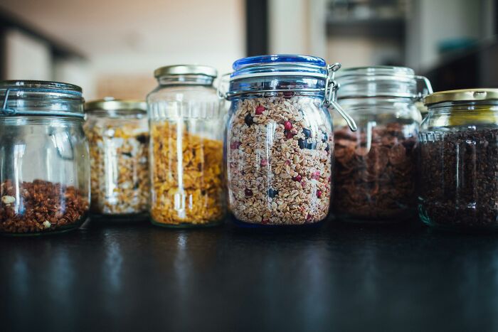Jars of cereal on a kitchen counter, a small-thing in a middle-class home setup.