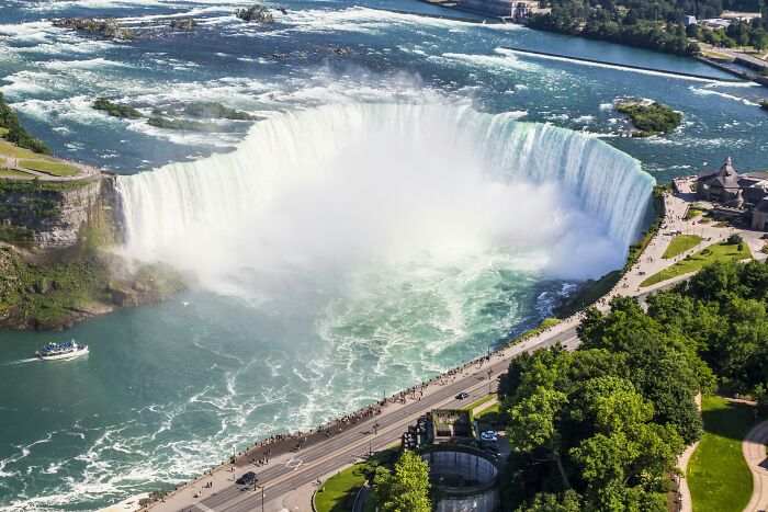 Aerial view of a large waterfall surrounded by lush greenery, often deemed less impressive by seasoned travelers.
