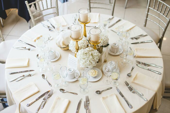 Elegant table setting with white flowers and folded napkins, symbolizing adult experiences of feeling left out.