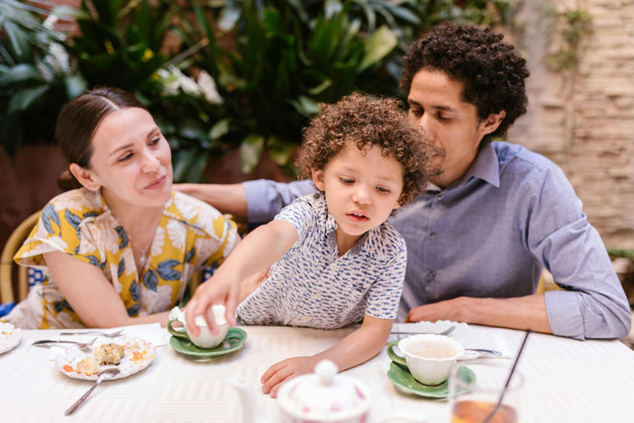 A family enjoying a meal at a pizza place, highlighting the atmosphere affected by unruly kids. A family enjoying a meal at a pizza place, highlighting the atmosphere affected by unruly kids.