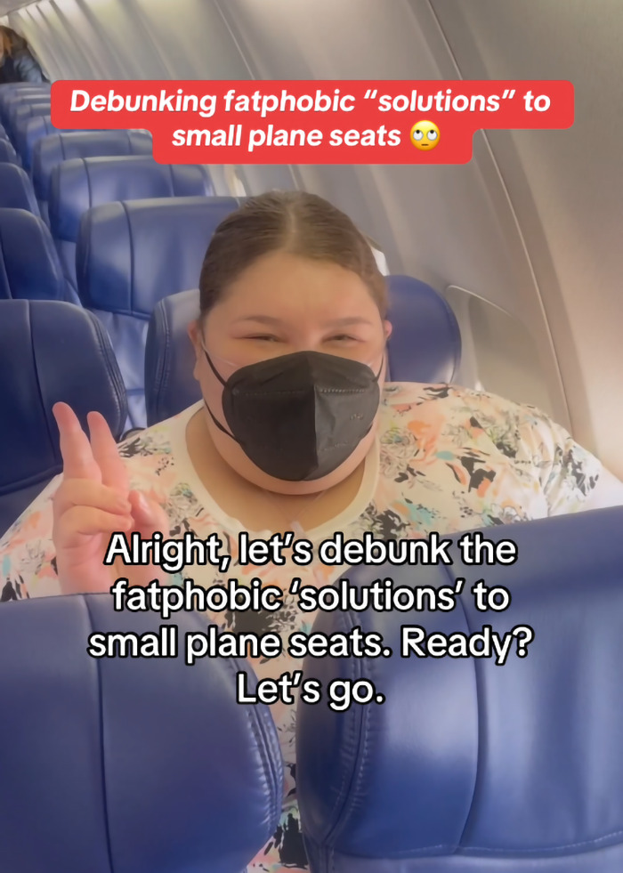 Plus-size woman in airplane seat, addressing criticism about paying extra to fly. Plus-size woman in airplane seat, addressing criticism about paying extra to fly.
