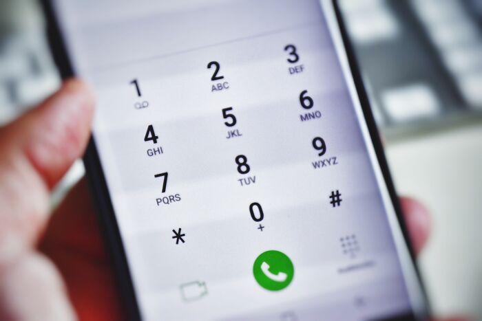 Close-up of a smartphone dial pad showcasing the concept of pretty privilege and its impact.