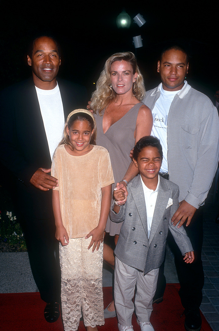 A family stands on a red carpet; includes O.J. Simpson, central to a private investigator's claims. A family stands on a red carpet; includes O.J. Simpson, central to a private investigator's claims.