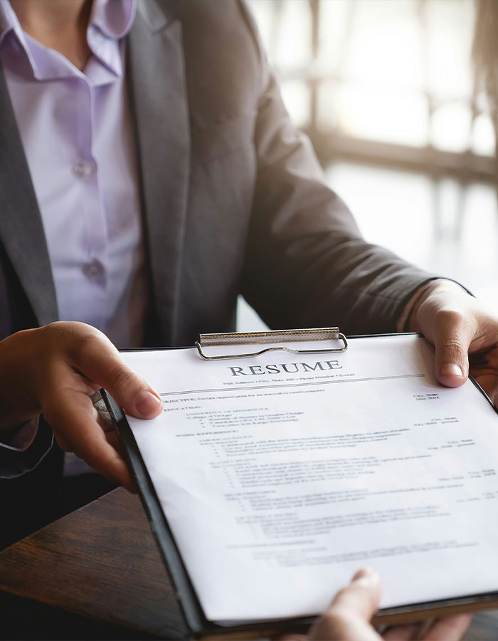 Person holding a résumé, highlighting common mistakes in résumé writing for 2025. Person holding a résumé, highlighting common mistakes in résumé writing for 2025.