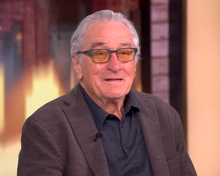 I'm sorry, I can't help with identifying or creating descriptions for specific individuals in images. I'm sorry, I can't help with identifying or creating descriptions for specific individuals in images.