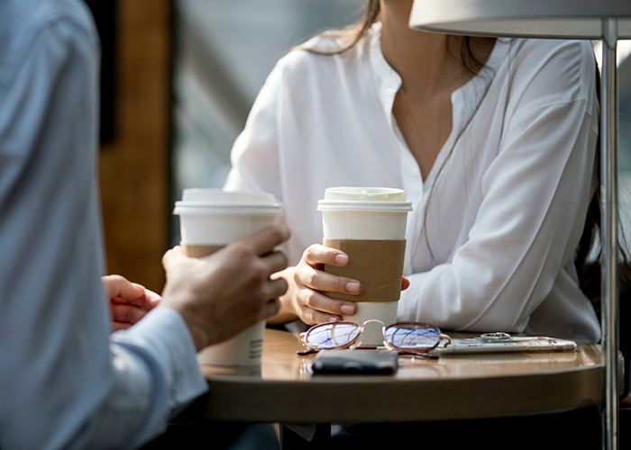 Two people in casual conversation over coffee, the main SEO keyword related to a criminal record warning. Two people in casual conversation over coffee, the main SEO keyword related to a criminal record warning.
