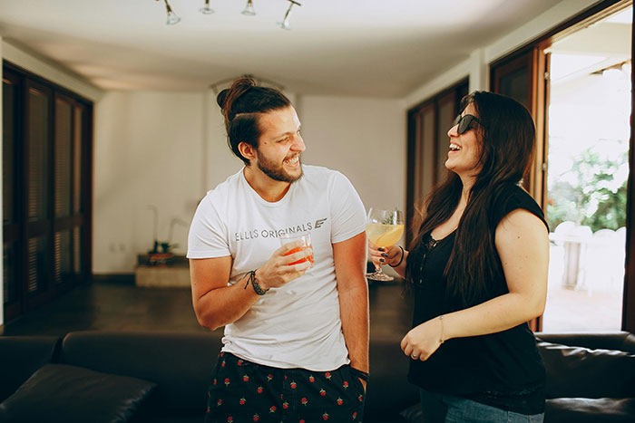 Young couple enjoying drinks indoors, illustrating togetherness and social interaction. Young couple enjoying drinks indoors, illustrating togetherness and social interaction.