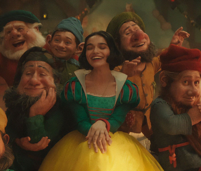 Image of Snow White smiling with seven dwarfs, promoting a Disney movie amid ongoing controversies. Image of Snow White smiling with seven dwarfs, promoting a Disney movie amid ongoing controversies.