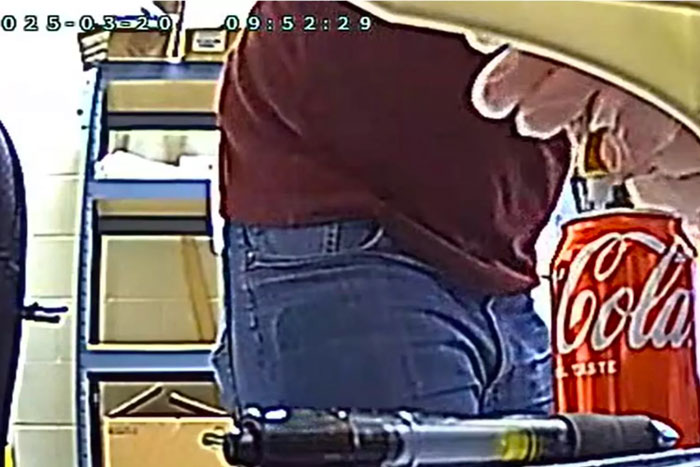 Spy cam footage of person near a Coke can in an office setting. Spy cam footage of person near a Coke can in an office setting.