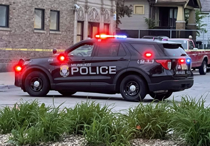Police car with lights on outside a building in Milwaukee, related to a coworker incident involving a Coke can. Police car with lights on outside a building in Milwaukee, related to a coworker incident involving a Coke can.