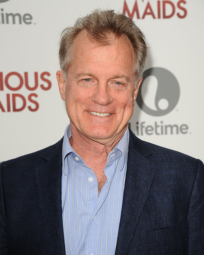 Disgraced actor at event, wearing a blue suit and striped shirt, with a backdrop featuring logos. Disgraced actor at event, wearing a blue suit and striped shirt, with a backdrop featuring logos.
