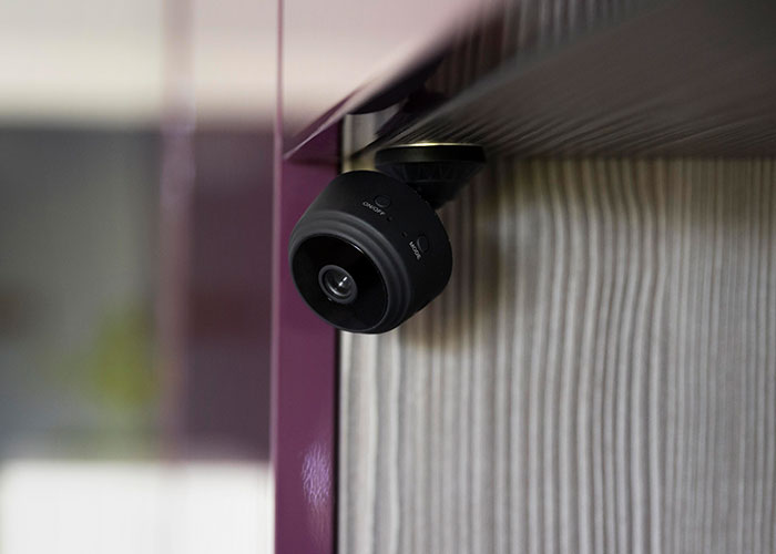 Hidden camera mounted discreetly on a wall corner. Hidden camera mounted discreetly on a wall corner.