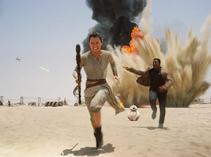 Three characters running from an explosion in a desert scene, exemplifying hype and expectations in film.