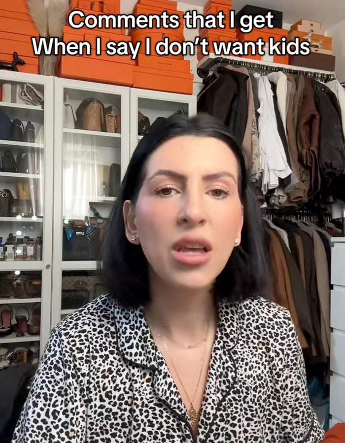 Millennial woman in leopard print discussing child-free lifestyle backlash in a closet setting. Millennial woman in leopard print discussing child-free lifestyle backlash in a closet setting.