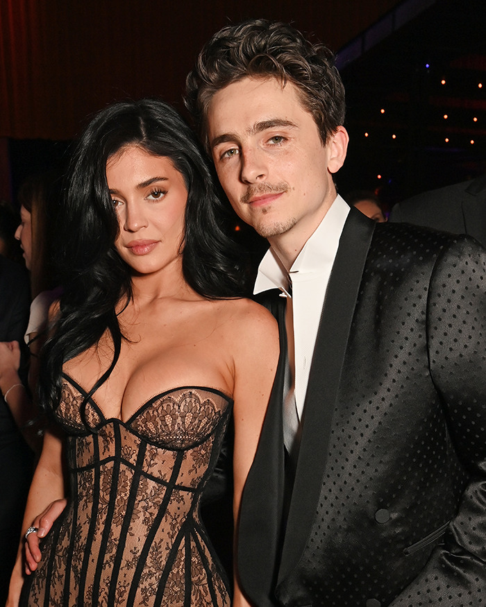 A man in a black tuxedo and a woman in a lace dress at a formal event. A man in a black tuxedo and a woman in a lace dress at a formal event.