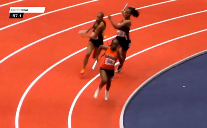 Track star running in a relay race, holding a baton on an indoor track. Track star running in a relay race, holding a baton on an indoor track.