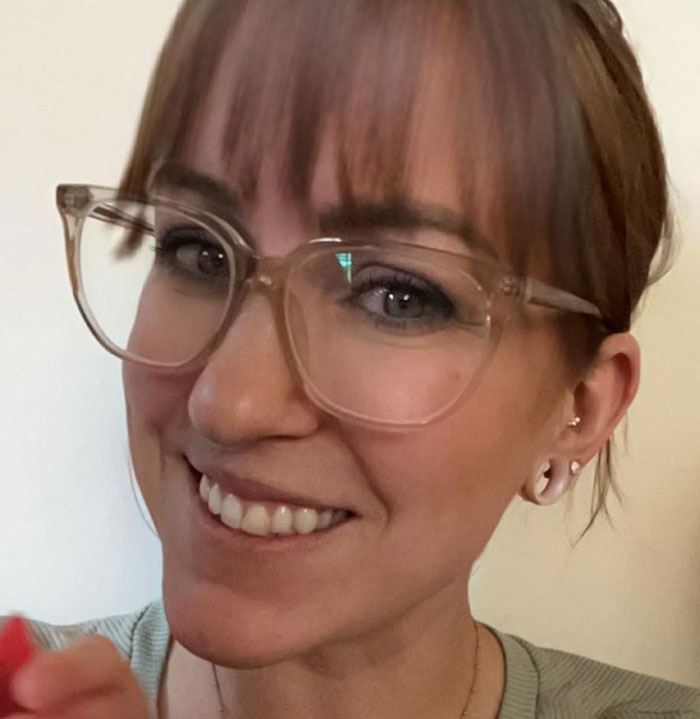 Woman smiling with glasses, relevant to "monster" mom report. Woman smiling with glasses, relevant to "monster" mom report.