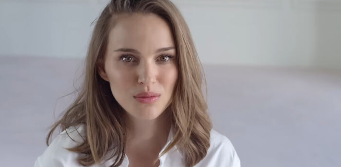 A celebrity with light brown hair, wearing a white top, against a neutral background.