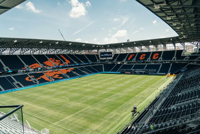 Modern soccer stadium with green pitch and FC Cincinnati seats, one of the cathedrals of soccer where legends are born