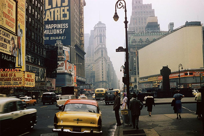 Vintage street scene showing everyday American life with 1950s cars, pedestrians, and classic billboard advertisements. Vintage street scene showing everyday American life with 1950s cars, pedestrians, and classic billboard advertisements.
