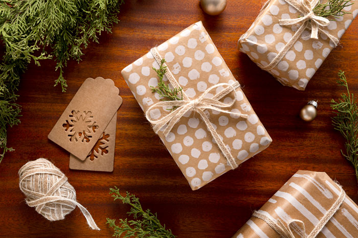 Gift exchange drama: wrapped presents on a wooden table with greenery, highlighting festive atmosphere. Gift exchange drama: wrapped presents on a wooden table with greenery, highlighting festive atmosphere.