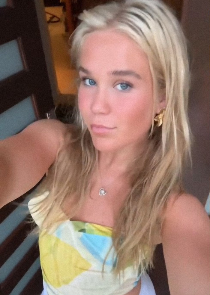 Young woman taking a selfie, wearing a colorful top indoors, related to viral sea foam stunt controversy. Young woman taking a selfie, wearing a colorful top indoors, related to viral sea foam stunt controversy.