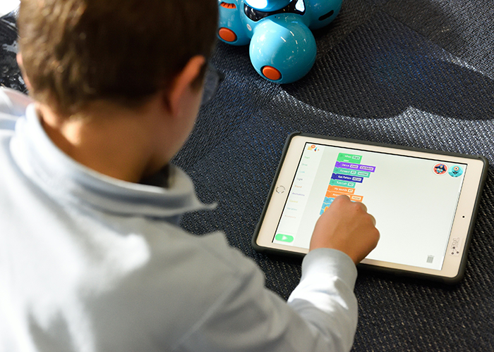 Child using a tablet on a carpet, engaging with educational content, illustrating concepts of gentle parenting and technology use. Child using a tablet on a carpet, engaging with educational content, illustrating concepts of gentle parenting and technology use.