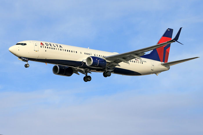 Delta airplane flying in blue sky; related to passenger seat drama involving handicapped grandma claim. Delta airplane flying in blue sky; related to passenger seat drama involving handicapped grandma claim.