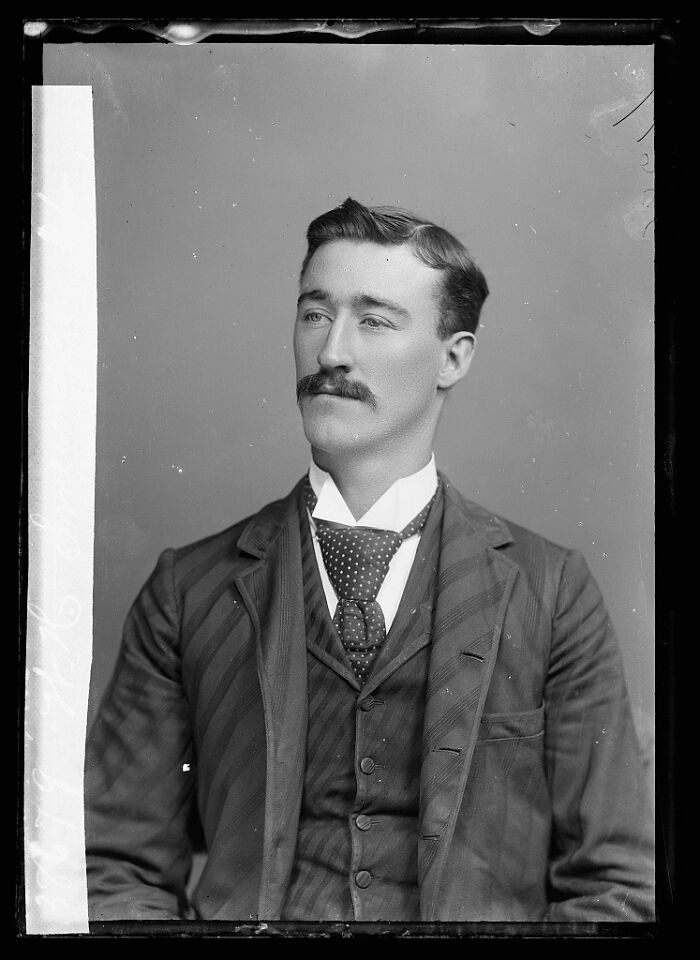Black and white portrait of a man from rare photographs rescued from glass negatives showing historical attire and style.