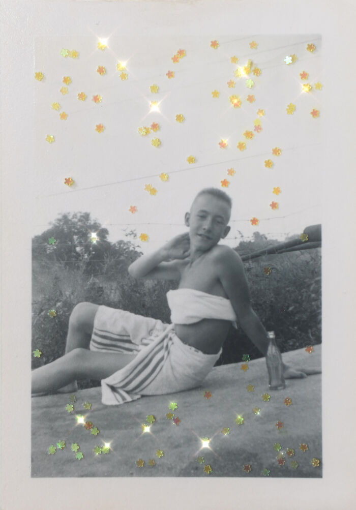 Young person wrapped in towels, sitting outdoors with festive sparkles; captures essence of 'An Impossibly Normal Life'.