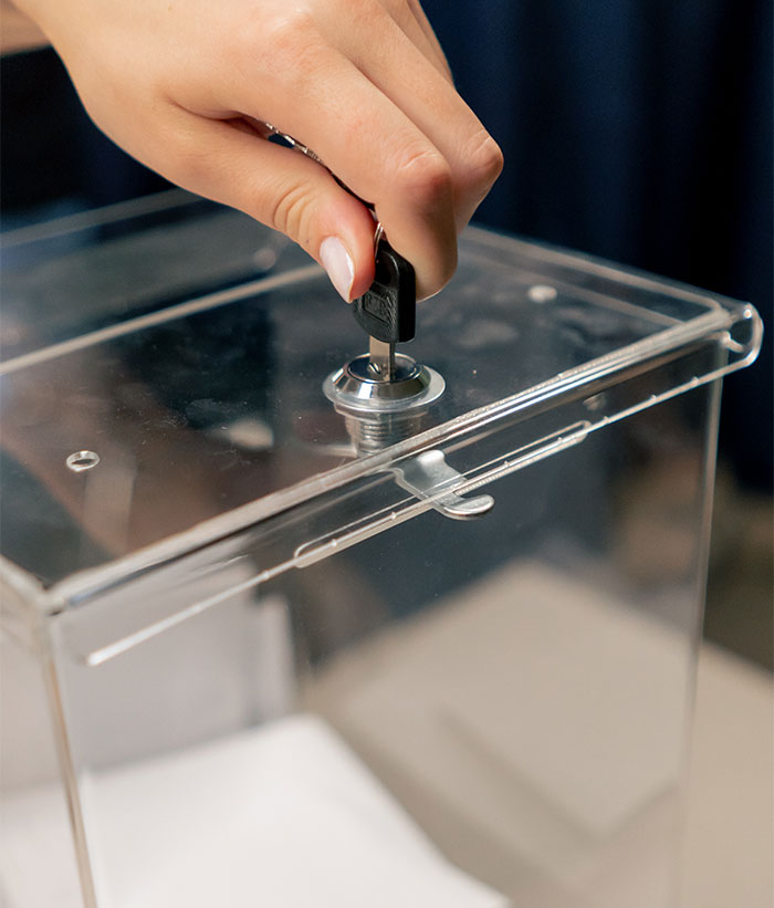 Hand locking a clear fridge lockbox to secure cheese from roommates. Hand locking a clear fridge lockbox to secure cheese from roommates.