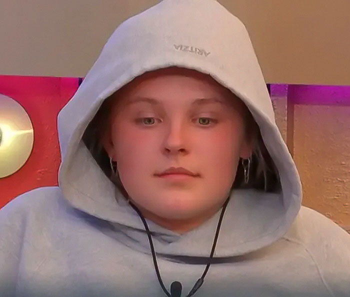 Person in a hoodie on Big Brother show, related to JoJo Siwa's recent moment. Person in a hoodie on Big Brother show, related to JoJo Siwa's recent moment.