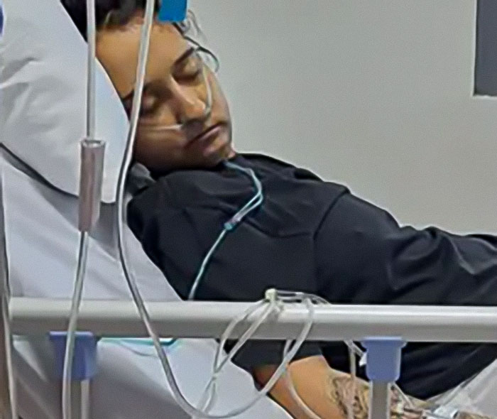 Young woman with tubes in hospital bed, related to mysterious illness during travel. Young woman with tubes in hospital bed, related to mysterious illness during travel.