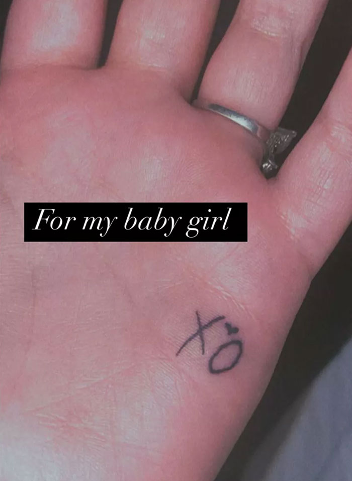 Hand with tattoo "xo" and ring, with text "For my baby girl" overlayed, linked to Demi Lovato. Hand with tattoo "xo" and ring, with text "For my baby girl" overlayed, linked to Demi Lovato.