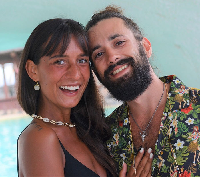 A smiling couple posing together, capturing a moment while traveling, related to mysterious illness awareness. A smiling couple posing together, capturing a moment while traveling, related to mysterious illness awareness.