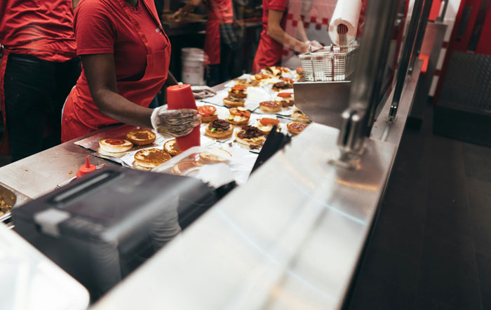 Employee follows break policy, as kitchen prep area becomes chaotic in busy restaurant environment. Employee follows break policy, as kitchen prep area becomes chaotic in busy restaurant environment.
