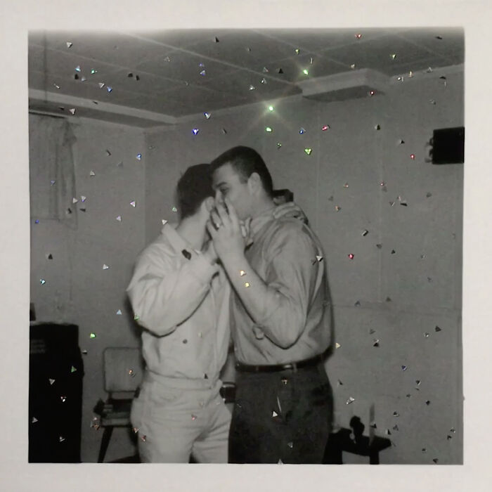 Two men dancing closely in a room, symbolizing love without boundaries.