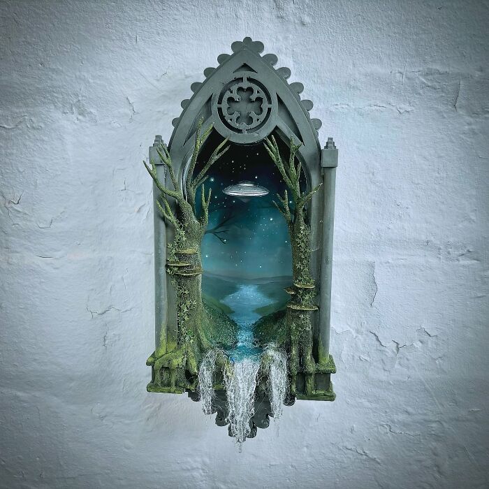 Alien-themed diorama by Caroline Dewison, featuring a mysterious UFO scene framed by gothic-style arch and trees.