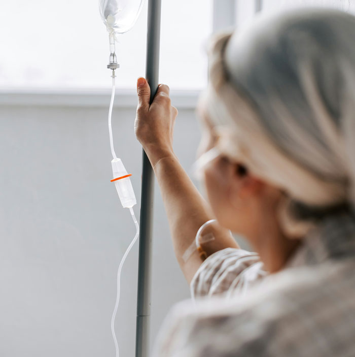 A young woman in a hospital setting, holding an IV pole, highlighting good credit score utilization. A young woman in a hospital setting, holding an IV pole, highlighting good credit score utilization.