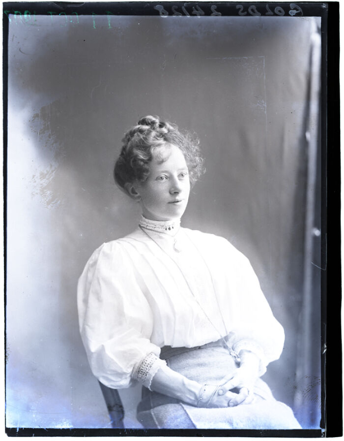 Vintage portrait of a woman seated in early 20th century attire, part of rare photographs rescued from glass negatives.