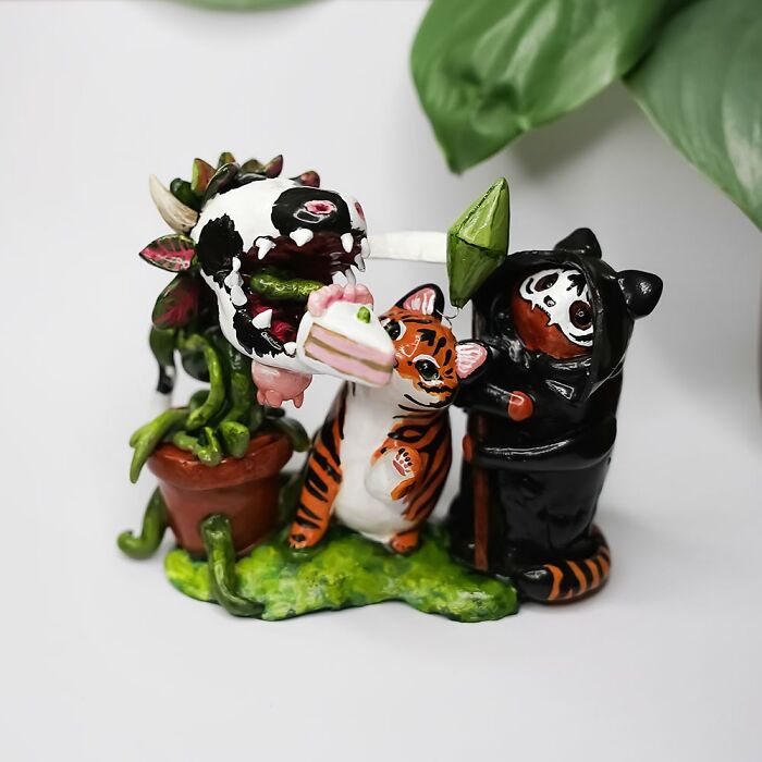 Whimsical pocket-sized animal figurines by Vallavica featuring tigers and plants in a playful scene.