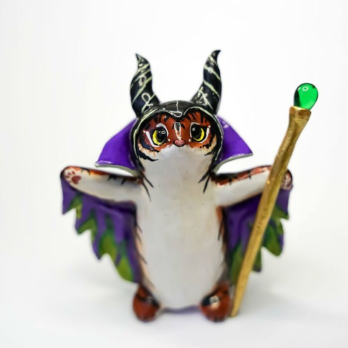 Adorable pocket-sized animal figurine by Vallavica, resembling a tiny creature with horns and a staff.