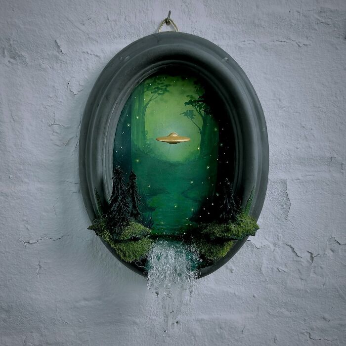 Alien-themed diorama by Caroline Dewison, featuring a UFO hovering over a mystical forest with a cascading waterfall.